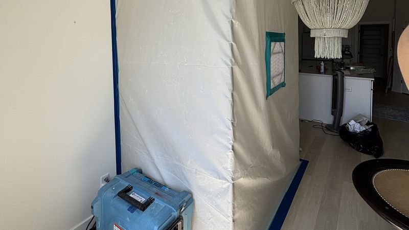 Sealed containment with negative air and drying equipment running during remediation