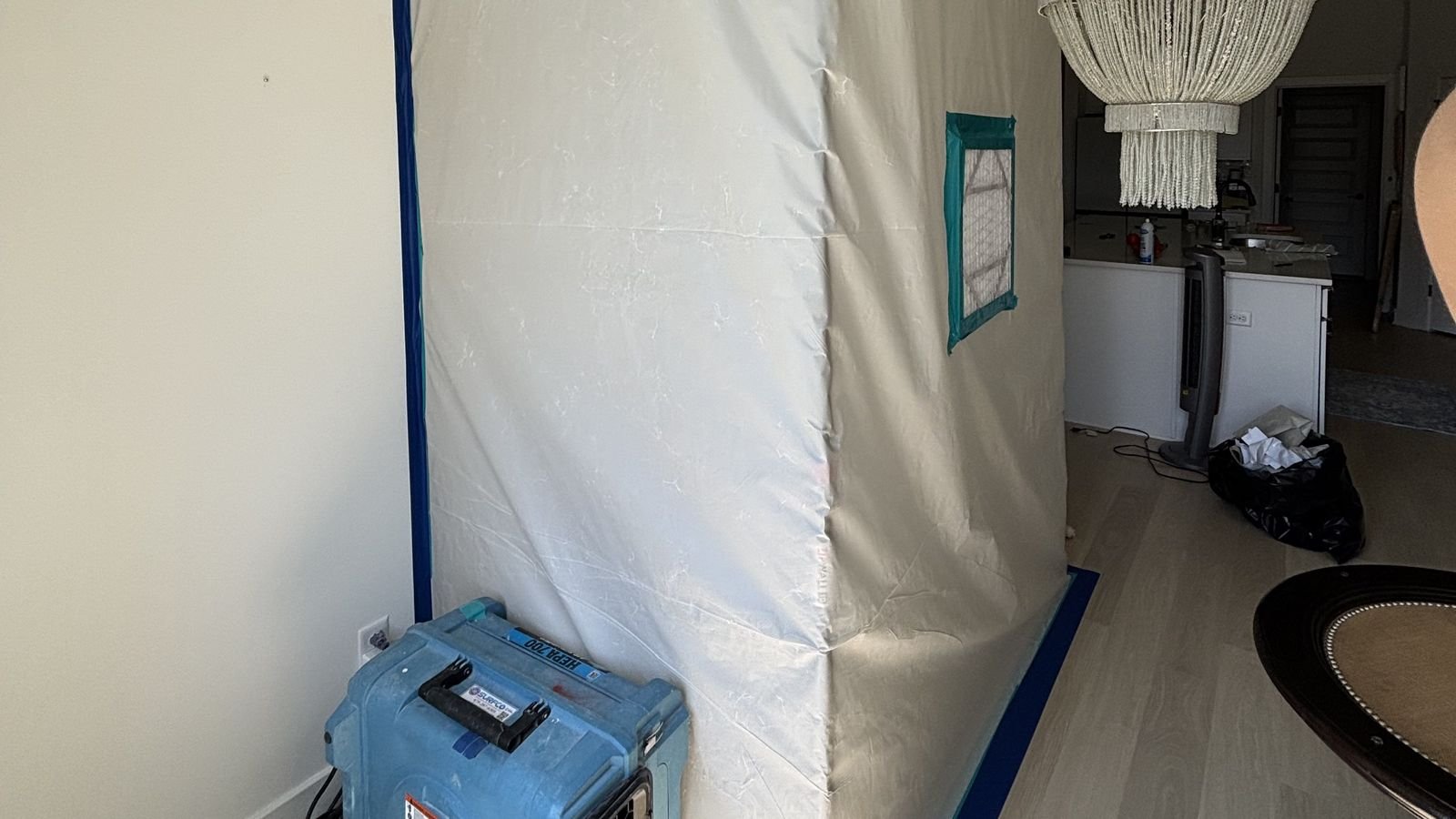 Containment barrier and dehumidifier set for structural drying after a water loss in a Northwest Arkansas home